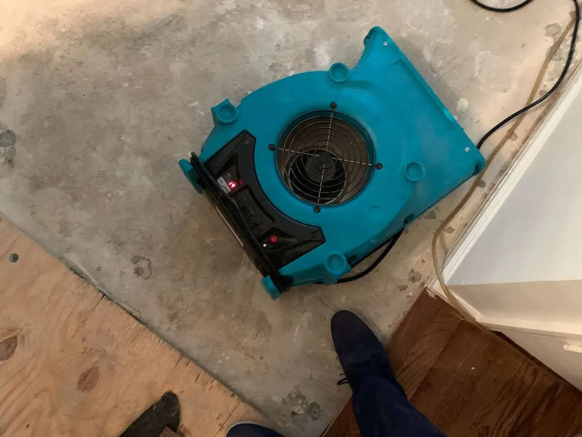 Air mover drying subfloor during Leak Detection & Repair in Camden
